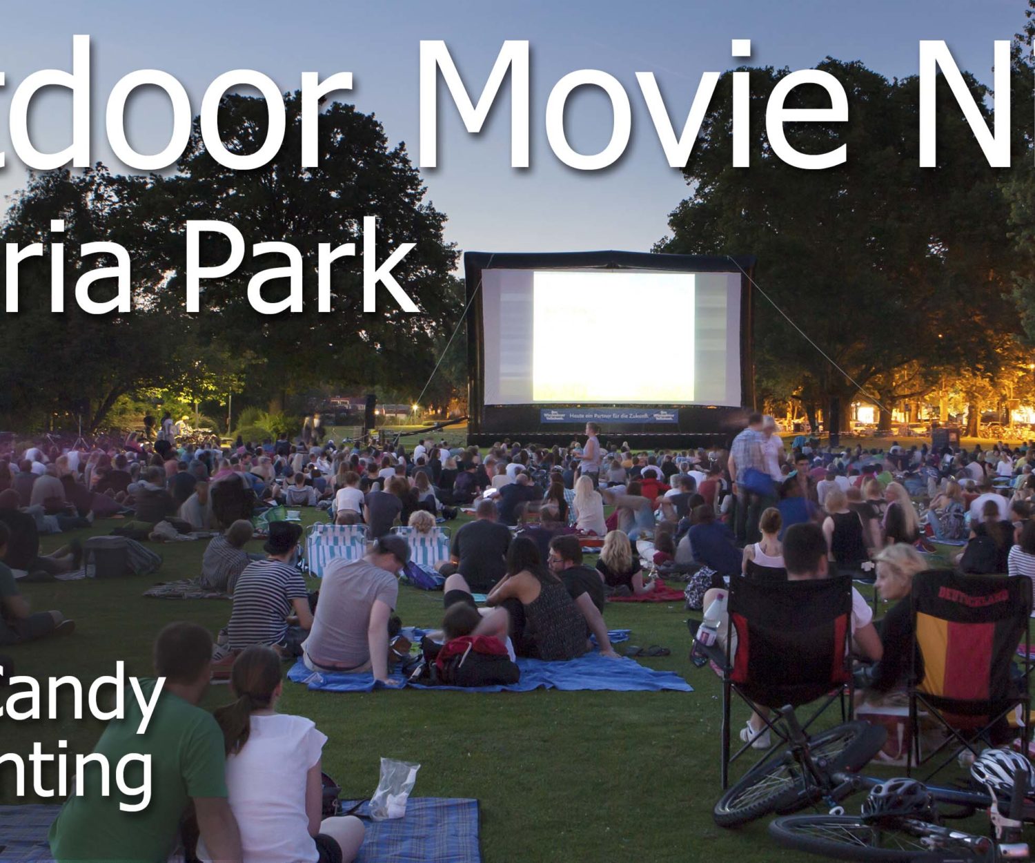 Spectators of Open-Air Cinema event at Reisinger park in the city center of Wiesbaden, Germany - sitting on the grass and watching the movie